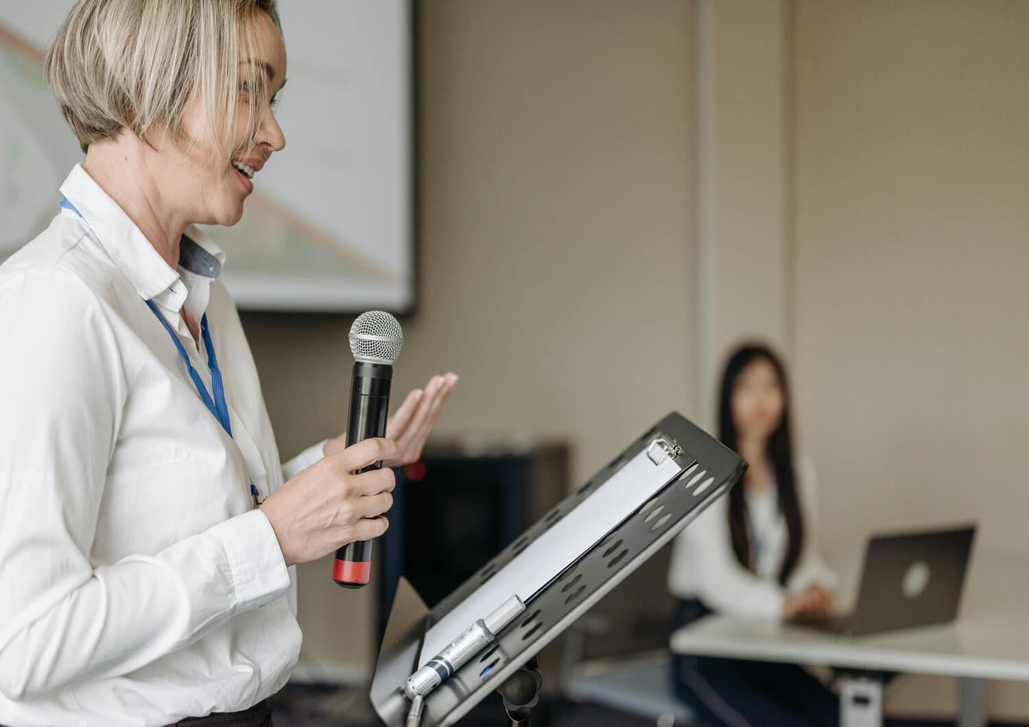 A speaker giving a talk during a conference supported by CTI Meeting Technology.